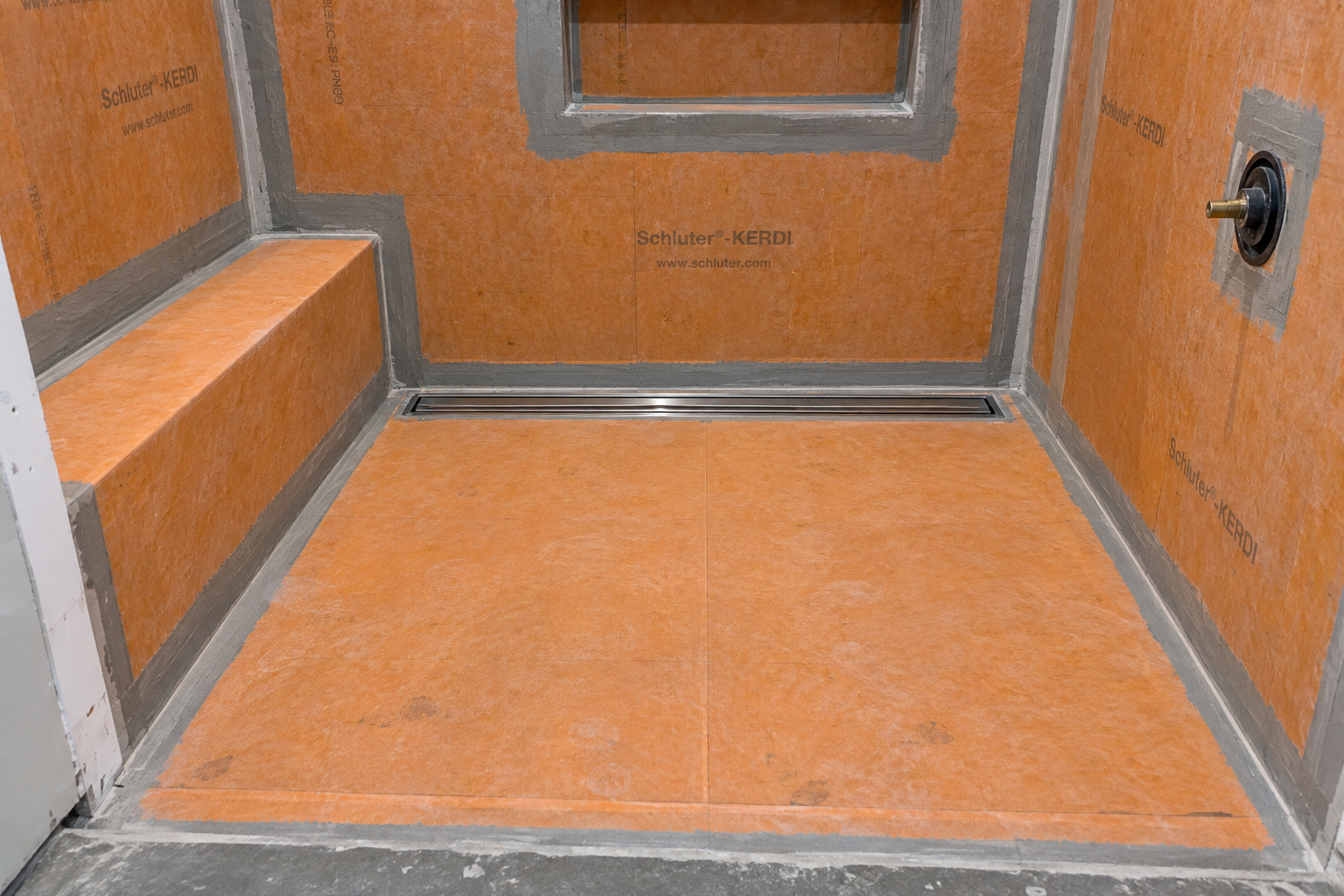 Prepared shower pan sloped toward the drain before tile installation